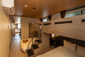 a room with two bunk beds and a desk at ReLA Kashiwa Eki Nishi in Kashiwa +30 photos