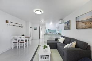 a living room with a couch and a table at Applecross - Perfect For A Weekend Escape in North Avoca