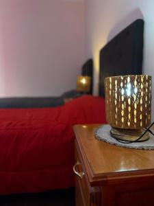 a bedroom with a bed and a cup on a table at Duna Blanca I in Fiambalá