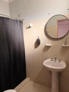 a bathroom with a sink and a toilet and a mirror at Duna Blanca I in Fiambalá