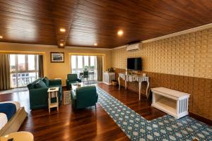 a living room with a couch and a table at State Beach Resort And Spa in Kannur