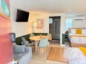 a hotel room with a bed and a table and a couch at Riverwalk Park Inn in Chelan