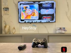 two video game controllers sitting on top of a table at Bali Residence Melaka By Heystay Management in Malacca +291 photos