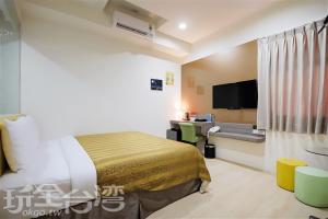 a hotel room with a bed and a flat screen tv at CoCo Motel Boutique in Puli