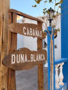two wooden signs that say duna blanca at Duna Blanca II in Fiambalá