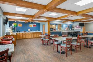 a restaurant with tables and chairs and a counter at Quality Inn & Suites Goshen in Goshen