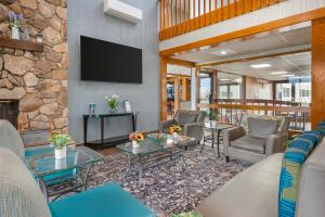 a lobby with couches and chairs and a stone wall at Quality Inn & Suites Goshen in Goshen