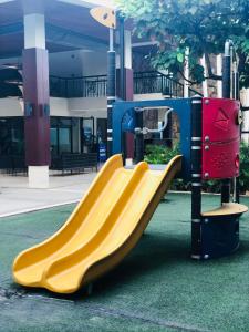 a slide in a playground in a building at Rochester Garden Condo in Manila