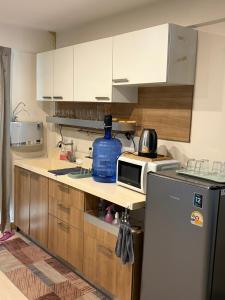 a kitchen with white cabinets and a refrigerator at Casa Nicola BKK in Ban Na Song +20 photos