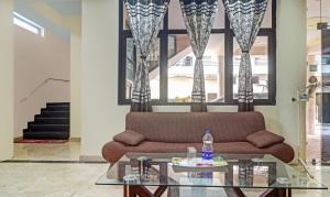 a living room with a couch and a glass table at Hotel Albie Stay,Near Railway Station Chandigarh in Chandīgarh