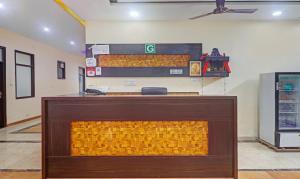 a lobby with a fireplace in the middle of a room at Hotel Albie Stay,Near Railway Station Chandigarh in Chandīgarh