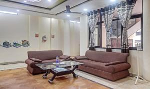 a living room with two couches and a coffee table at Hotel Albie Stay,Near Railway Station Chandigarh in Chandīgarh