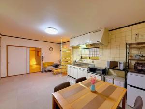 a kitchen with a table and a dining room at Ema-長吉 in Osaka +40 photos