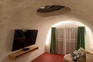 a living room with a flat screen tv and a couch at Mr Lapin in Santiago Sacatepéquez