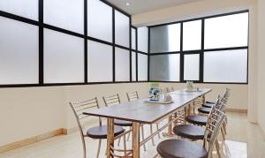 a dining room with a table and chairs at Hotel Albie Stay,Near Railway Station Chandigarh in Chandīgarh