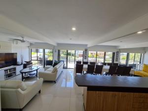 a living room with couches and a bar at Mollymook Beach Haven - near ocean & golf course in Mollymook