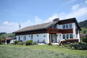 a white house with a brown roof at Ferienwohnungen Fricker in Oberstdorf