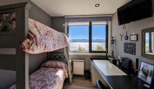 a bedroom with a bunk bed and a desk at Lakefront, Jacuzzi and Pool in San Carlos de Bariloche