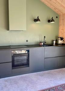 a kitchen with a sink and a stove at Architect-Designed House In Etelhem, Gotland in Stånga