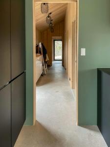 a hallway of a house with green walls at Architect-Designed House In Etelhem, Gotland in Stånga