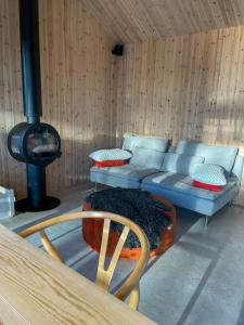 a living room with a blue couch and a stove at Architect-Designed House In Etelhem, Gotland in Stånga +20 photos