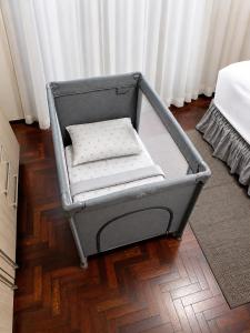a gray chair with a pillow on a wooden floor at Flat Completo - Cozinha - Lavadora - Climatizado in Erval dʼOeste