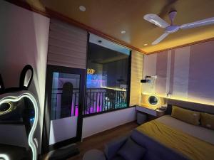 a bedroom with a bed and a ceiling fan at ChillDate in Bắc Ninh