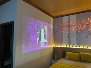 a bedroom with a bed and a purple wall at ChillDate in Bắc Ninh