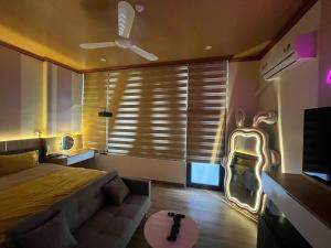 a bedroom with a bed and a couch and a tv at ChillDate in Bắc Ninh +2 photos