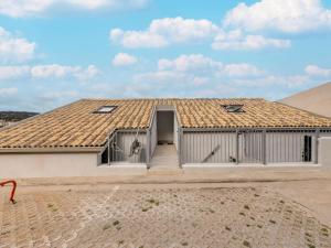a white house with a roof with a door at Brand new attic studio apartment, air conditioned in Castelsardo
