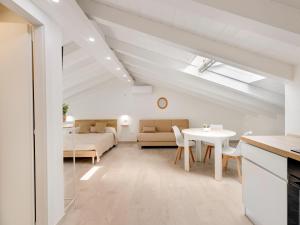 a living room with a table and a bed at Brand new attic studio apartment, air conditioned in Castelsardo