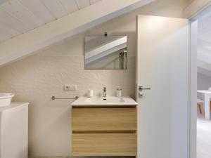 a bathroom with a sink and a mirror at Brand new attic studio apartment, air conditioned in Castelsardo +18 photos