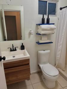 a bathroom with a sink and a toilet and a mirror at Casa privada con estacionamiento in Hermosillo +24 photos