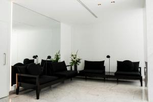 a living room with two black couches and a mirror at Top Rentals Downtown in Buenos Aires +65 photos