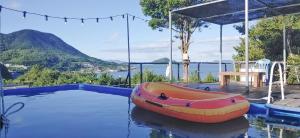 a inflatable boat sitting on the water in a swimming pool at Yeosu Maru Pension in Yeosu