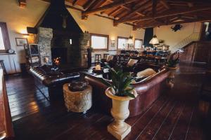 a living room with leather furniture and a fireplace at Ancient Monastery In The Lariani Mountains in Cernobbio