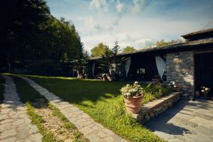 a house with a potted plant in front of a yard at Ancient Monastery In The Lariani Mountains in Cernobbio