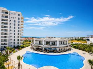 an aerial view of a building and a swimming pool at Caesar Blue Collection Nothern Cyprus Family Bedroom Suites in Ayios Dhometios
