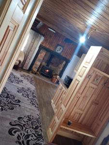 an open room with wooden doors and a fireplace at Глинобитні будиночки in Darakhov