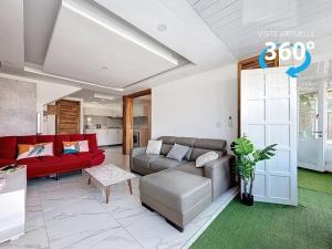 a living room with a couch and a red sofa at Les Sables Roses Appartement in Flic-en-Flac +7 photos