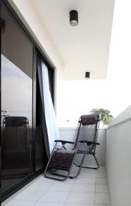 a chair sitting on top of a balcony at SanRosa Boutique Hotel BnB in Bulalakao +4 photos