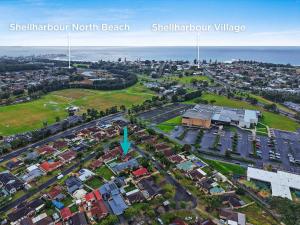 an aerial view of a suburb with a blue arrow at Flinders Hideaway in Shellharbour