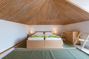 a bedroom with two beds and a wooden ceiling at Apartments LIMA Lazaneo in Jelsa +14 photos