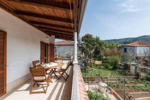 a patio with a table and chairs on a balcony at Apartments LIMA Lazaneo in Jelsa