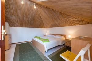 a bedroom with a bed and a wooden ceiling at Apartments LIMA Lazaneo in Jelsa