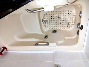 a white bath tub with a sink in it at Emerald Oceano Mar in Copacabana +48 photos