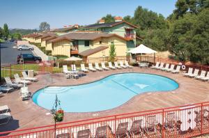 a view of a swimming pool with chairs and tables at Angels Camp Resort 3BR Apartment in Angels Camp
