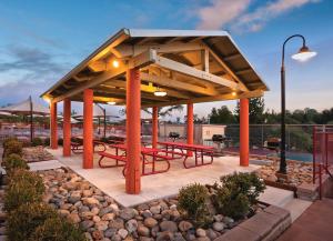 a pavilion with red picnic tables in a park at Angels Camp Resort 3BR Apartment in Angels Camp