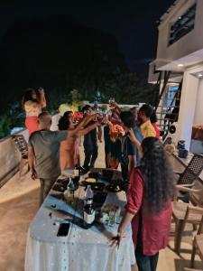 a group of people standing around a table at Sky Glow Residence in Pepiliyana +20 photos