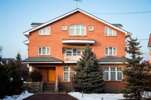 a large red brick house with a porch at Interhouse Almaty in Almaty